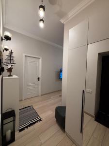 a living room with white walls and wooden floors at ELAY Apartments in Baku