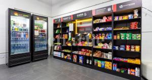 a store aisle with shelves of food and drinks at Paulista Suites by Charlie in Sao Paulo