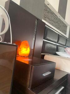 a lamp on a table next to a bed at Blue Maizon in Heraklio Town +1 photo