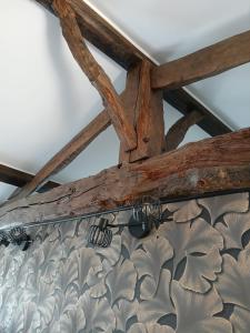 a wooden ceiling with a chandelier hanging from it at Gîte Héloïse in Le Pallet