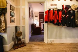 a room with a hallway with clothes hanging on a wall at Lord Kitcheners Guest House in Lowestoft