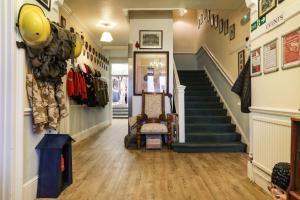a hallway of a store with stairs and a stair case at Lord Kitcheners Guest House in Lowestoft