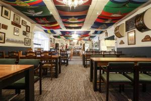 a restaurant with tables and chairs and a colorful ceiling at Lord Kitcheners Guest House in Lowestoft