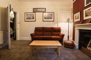 a living room with a couch and a coffee table at Lord Kitcheners Guest House in Lowestoft