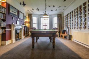 a room with a pool table in the middle of it at Lord Kitcheners Guest House in Lowestoft