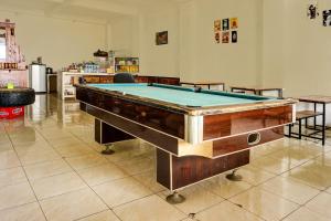 a pool table in the middle of a room at OYO Life 92499 Bagas Homestay Wonokitri in Pasuruan