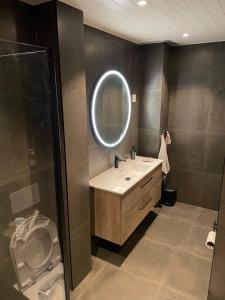 a bathroom with a sink and a mirror at Lars sitt hus in Lillehammer +5 photos
