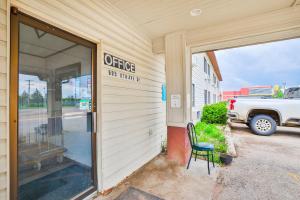 a sign on the side of a store with a chair outside at OYO Hotel Pipestone MN, Canterbury Park in Pipestone