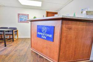 a podium in an office with a sign on it at OYO Hotel Pipestone MN, Canterbury Park in Pipestone +65 photos