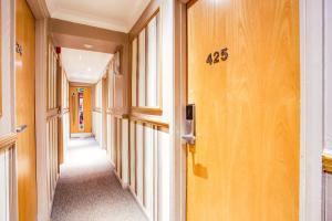 a hallway of a building with a number on the wall at Somerset Hotel Baker Street London in London
