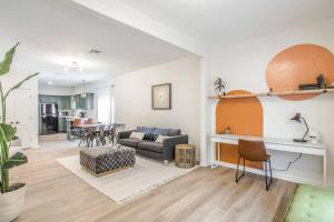 a living room with a couch and a table at The Arches Walk To Western Ave District in Oklahoma City