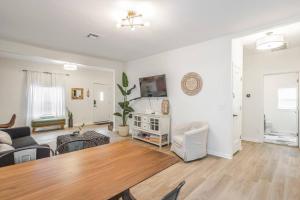 a living room with a table and a couch at The Arches Walk To Western Ave District in Oklahoma City