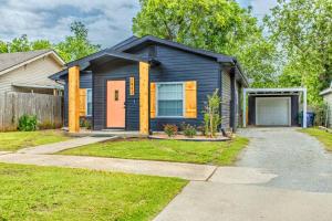 a black house with a garage in a yard at The Arches Walk To Western Ave District in Oklahoma City
