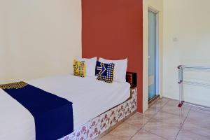 Ένα ή περισσότερα κρεβάτια σε δωμάτιο στο Hotel O Penginapan Kangean SyariahNearTaman Merdeka Kalianget