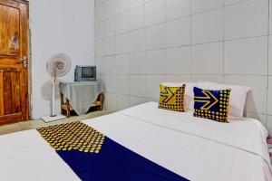 Ένα ή περισσότερα κρεβάτια σε δωμάτιο στο Hotel O Guest House Pak Darso
