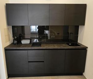 a kitchen with black cabinets and a counter top at Golden Moon in Lido di Ostia