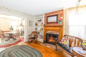 a living room with a fireplace and a table at Briarstone Inn Unit 3 in Galena