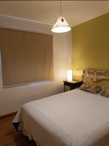 En eller flere senge i et værelse på Departamento centrico soñado