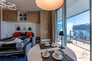 a bedroom with a bed and a table with dishes on it at Luxury by the Sea - Free Park - Gym - UltraWiFi in Genova