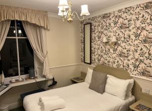 Postel nebo postele na pokoji v ubytování Windermere Lynwood Guest House + 7 fotografií