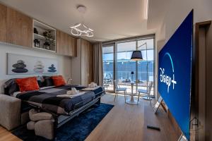 a bedroom with a bed and a table with chairs at Luxury by the Sea - Free Park - Gym - UltraWiFi in Genova