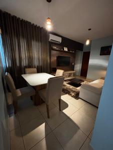 a living room with a table and chairs and a couch at Smart Apê! in Porto Velho