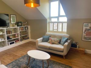 a living room with a couch and a table at Contemporary apartment in Cromer in Cromer