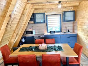 a dining room with a wooden table and chairs at Vezirove zore in Paraćin
