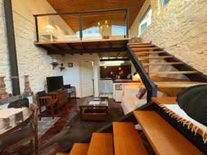 a living room with a staircase leading to a kitchen at Casa do Poço Funchal in Funchal