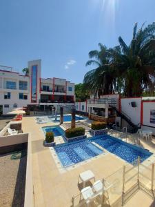 a large swimming pool with chairs and a building at Bora Beach Club in Melgar +39 photos
