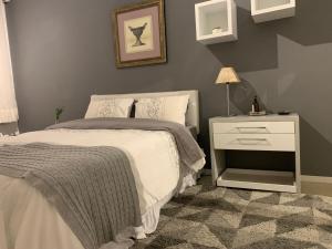 a bedroom with a bed and a night stand with a lamp at Flat Leblon inn in Rio de Janeiro