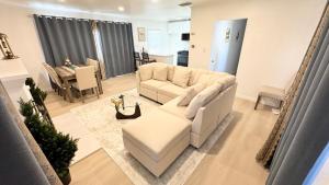 a living room with a white couch and a table at Newly renovated, warm home with 4 bedrooms, 14 miles from Disney in Whittier