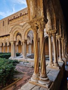 an old building with columns in the courtyard at Casa Normanna in Monreale