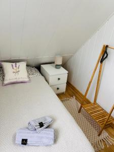 a bedroom with a bed with a towel on it at Domek Natura Rybno in Rybno