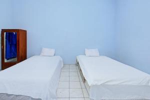 Ένα ή περισσότερα κρεβάτια σε δωμάτιο στο Hotel O Mareje Sariguna +17 φωτογραφίες