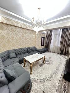 a living room with a couch and a table at Apartment 3 in Dushanbe