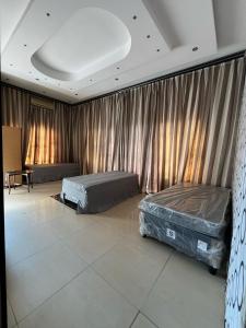two beds in a room with curtains at Peace & Homely Residence in Durban