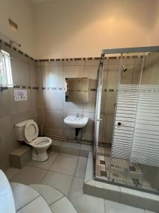 a bathroom with a toilet and a sink at Peace & Homely Residence in Durban