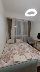 a bedroom with a large bed with two pillows on it at Apartment Skopje in Skopje