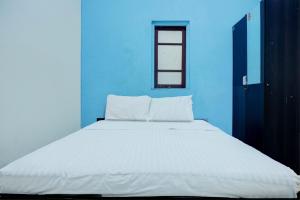Ένα ή περισσότερα κρεβάτια σε δωμάτιο στο Hotel O Wisma Padi Syariah PanyipatanNearWisata Gunung Birah