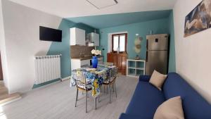 a living room with a table and a blue couch at La Casa Di Memole in Giaveno