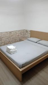a bedroom with a bed with white sheets at La casina al mare in Bari