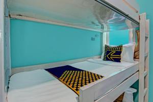 a bunk bed in a room with a blue ceiling at Hotel O Lobak Hostel CapsuleNearAyam Goreng Terowongan in Alastuwo