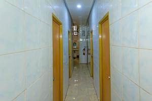 a corridor of a hospital hallway with two doors at Hotel O Bintaro in South Tangerang