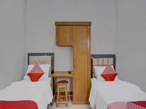 Кровать или кровати в номере Hotel O Bahagia Homestay SyariahNearMonument Park City Sand Pengaraian