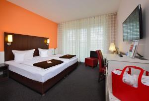 Postel nebo postele na pokoji v ubytování Best Western Plus Konrad Zuse Hotel + 37 fotografií