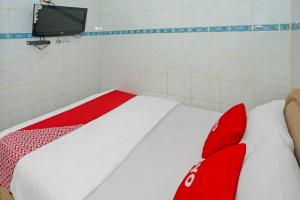 En eller flere senge i et værelse på Hotel O Melati