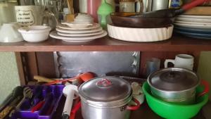 a shelf with dishes and utensils in a kitchen at Rincón verde in Eldorado