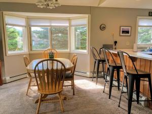 a kitchen and dining room with a table and chairs at FV16 Fairway Village Condo in Carroll