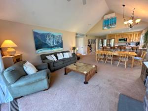 a living room with a couch and a table at FV21 Warm Fairway Village Townhome in Carroll